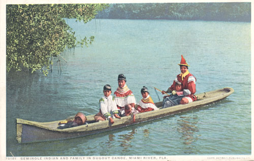 Seminole Indian family in dugout canoe